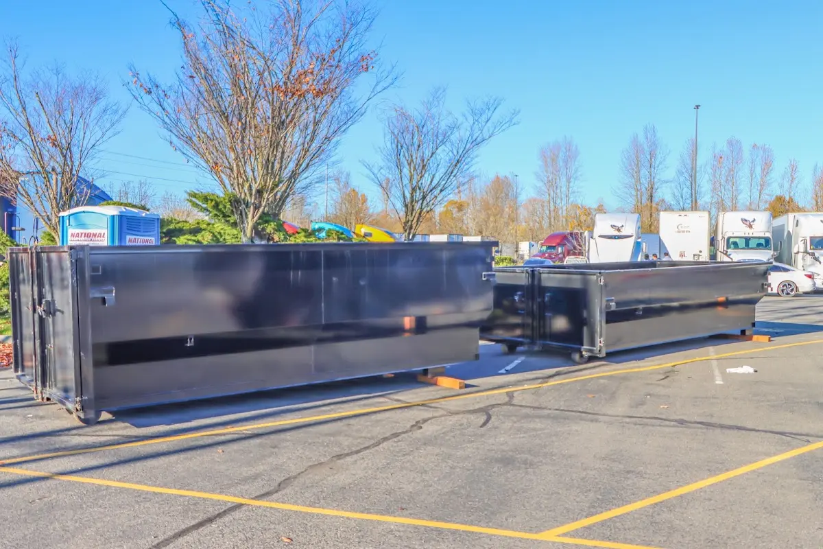 Professional dumpster rental service with roll-off container on residential driveway in Kannapolis
